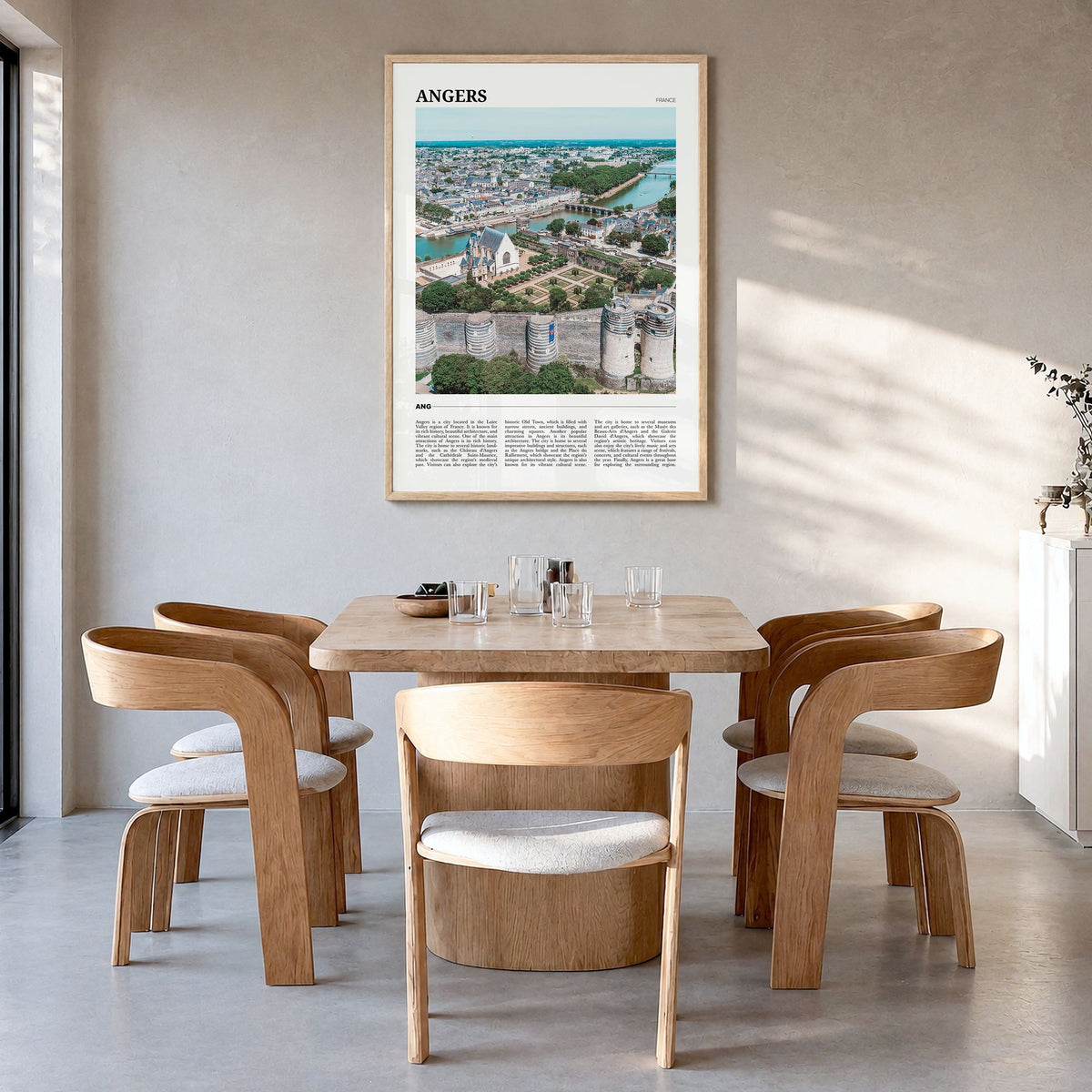 Angers Travel Poster in a natural wood frame, hanging in a dining room