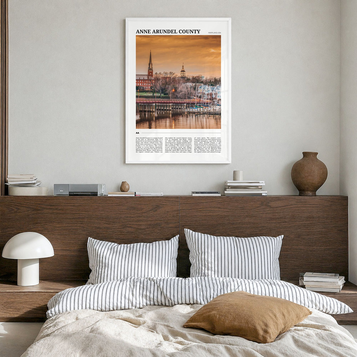 Anne Arundel County Travel Poster in a white wood frame, hanging in a bedroom