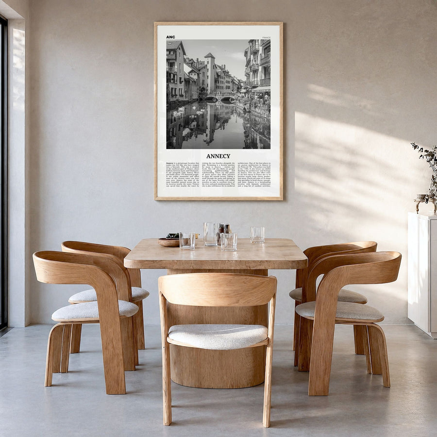 Annecy Newspaper Poster in a natural wood frame, hanging in a dining room