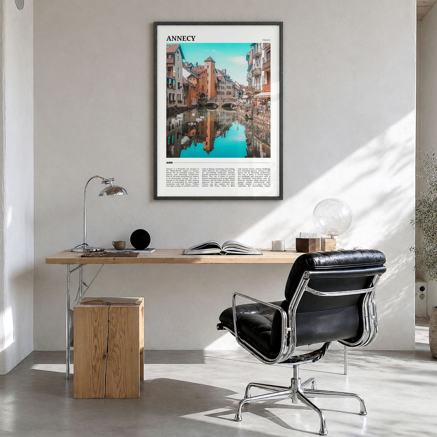 Annecy Travel Poster in a black wood frame, hanging in a bright home office