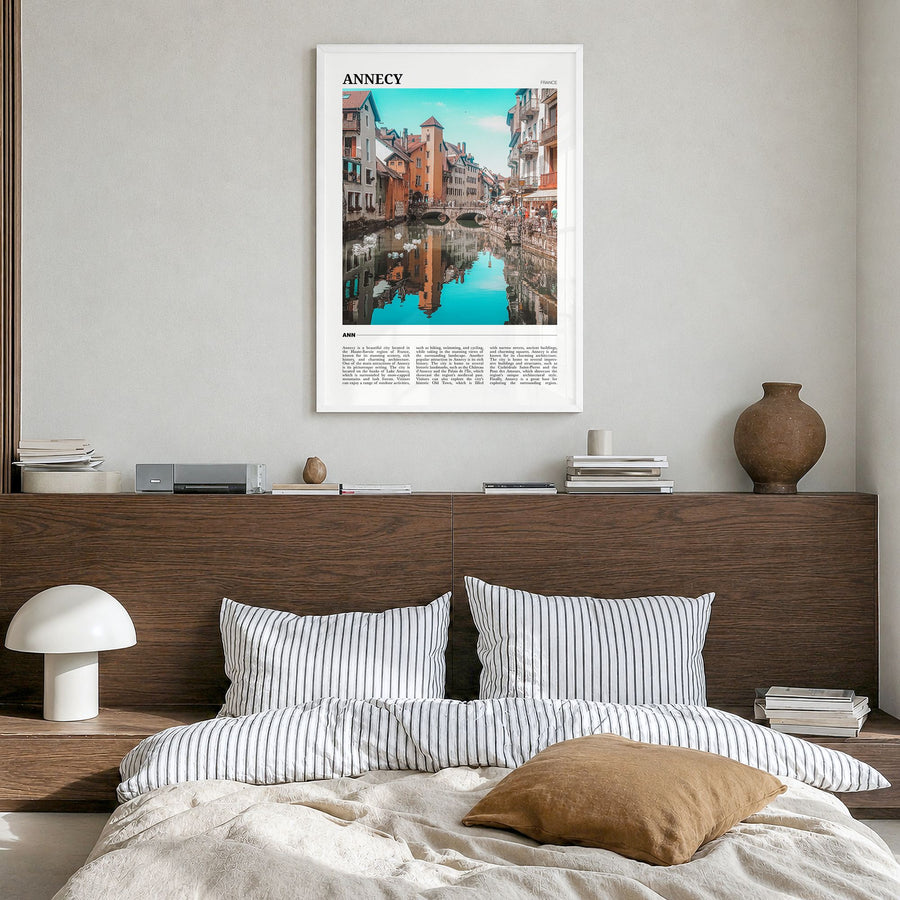 Annecy Travel Poster in a white wood frame, hanging in a bedroom