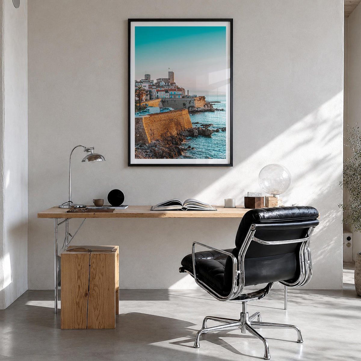Antibes colorful photo poster of France – vertical wall art in black wood frame with white border, hanging on wall