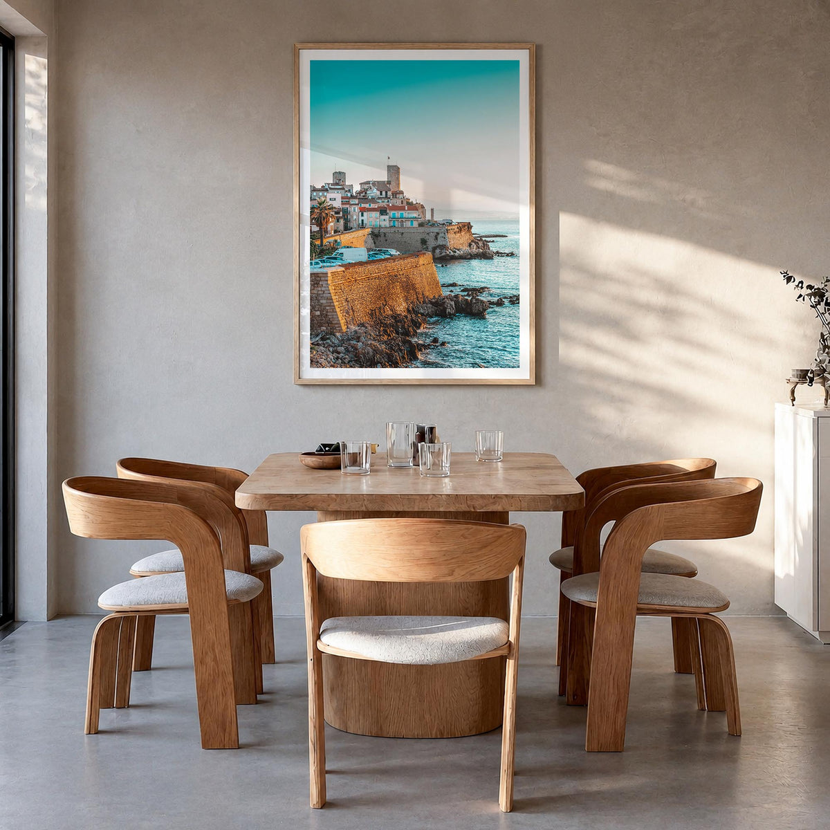 Antibes colorful photo poster of France – vertical wall art in natural wood frame with white border, hanging on wall