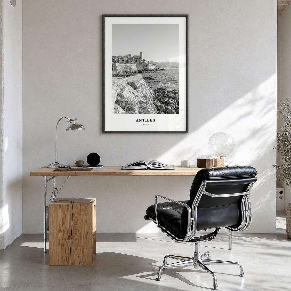 Antibes Classic Poster in a black wood frame, hanging in a bright home office