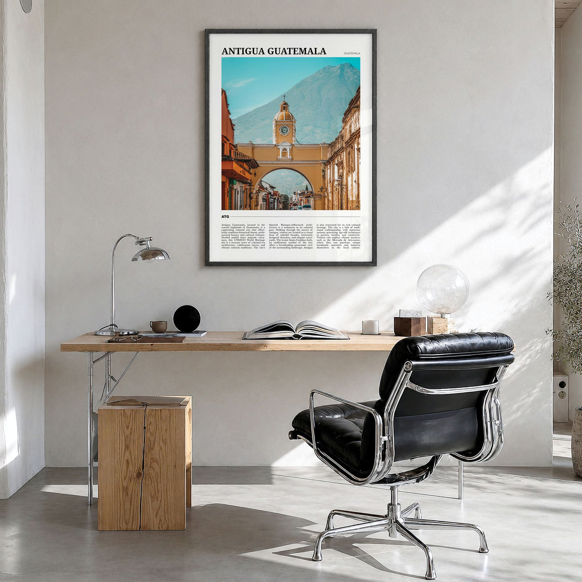 Antigua Guatemala Travel Poster in a black wood frame, hanging in a bright home office