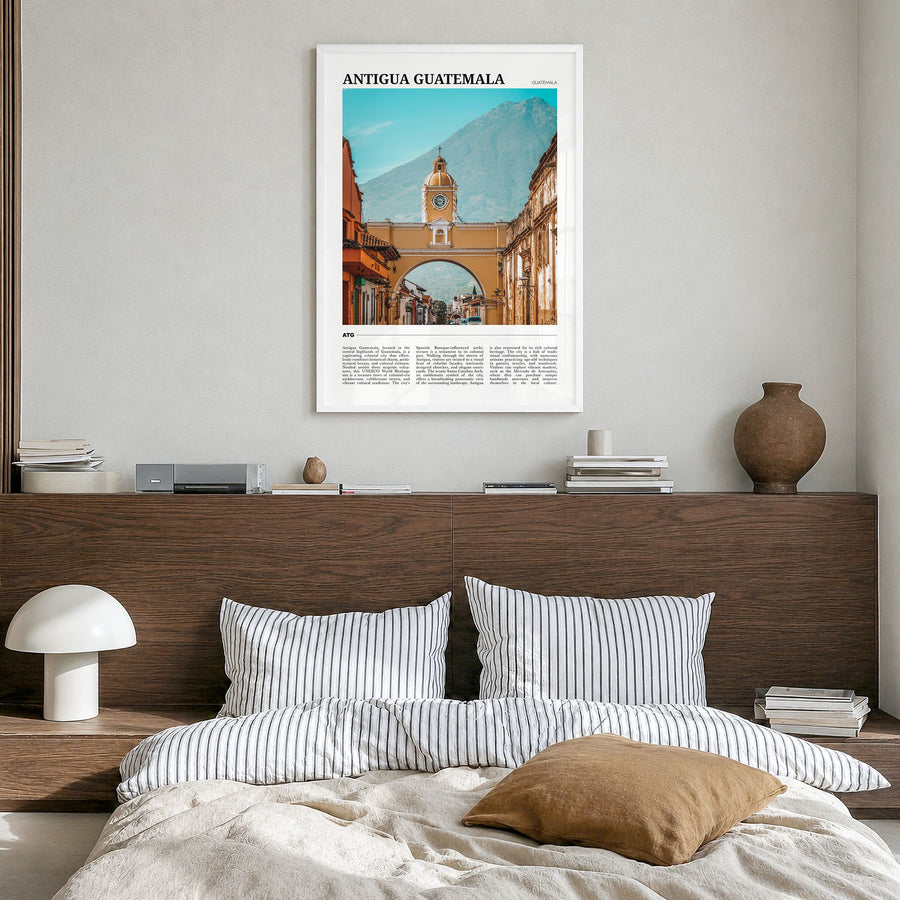 Antigua Guatemala Travel Poster in a white wood frame, hanging in a bedroom
