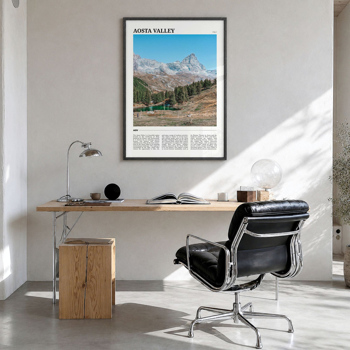 Aosta Valley Travel Poster in a black wood frame, hanging in a bright home office