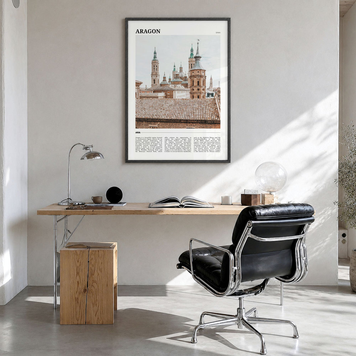 Aragon Travel Poster in a black wood frame, hanging in a bright home office
