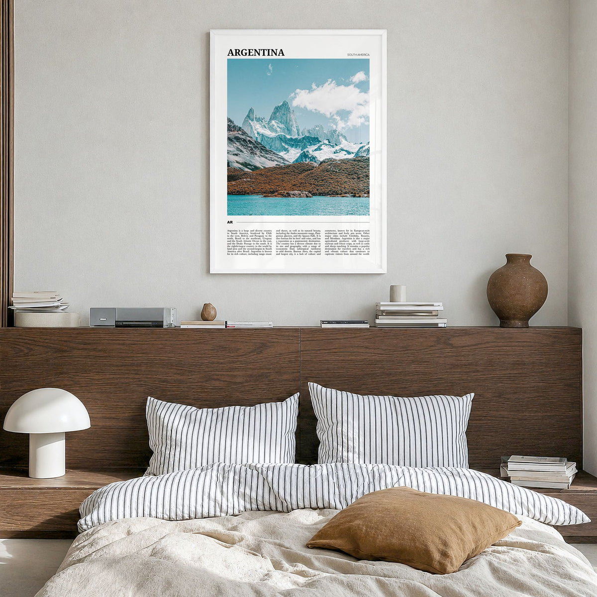 Argentina Travel Poster in a white wood frame, hanging in a bedroom