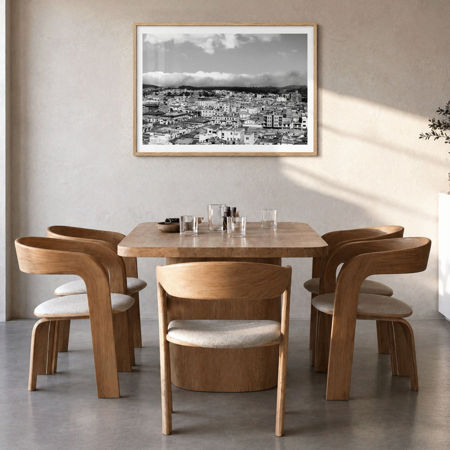 Asmara Photo Poster in a natural wood frame, hanging in a dining room, white border