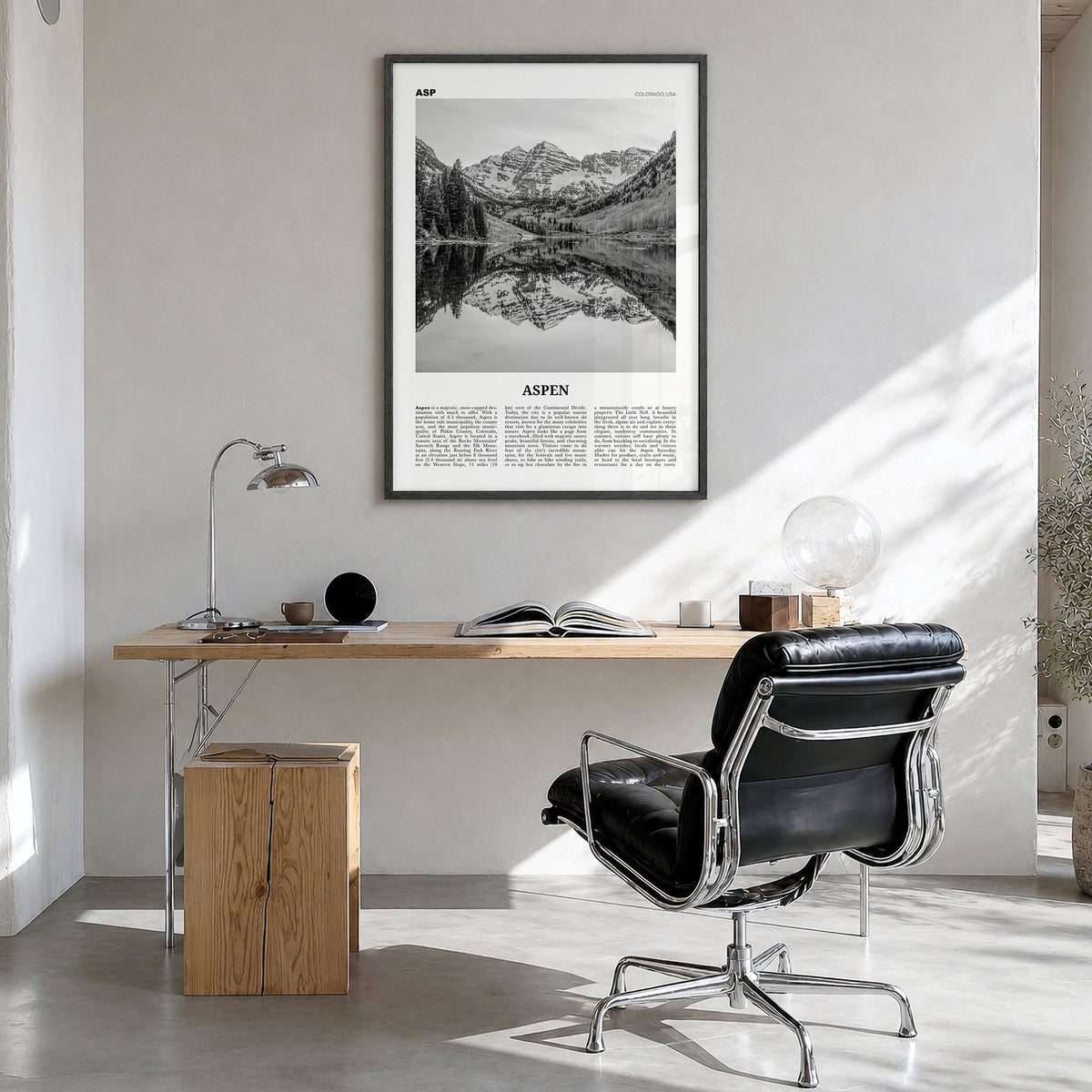 Aspen Newspaper Poster in a black wood frame, hanging in a bright home office