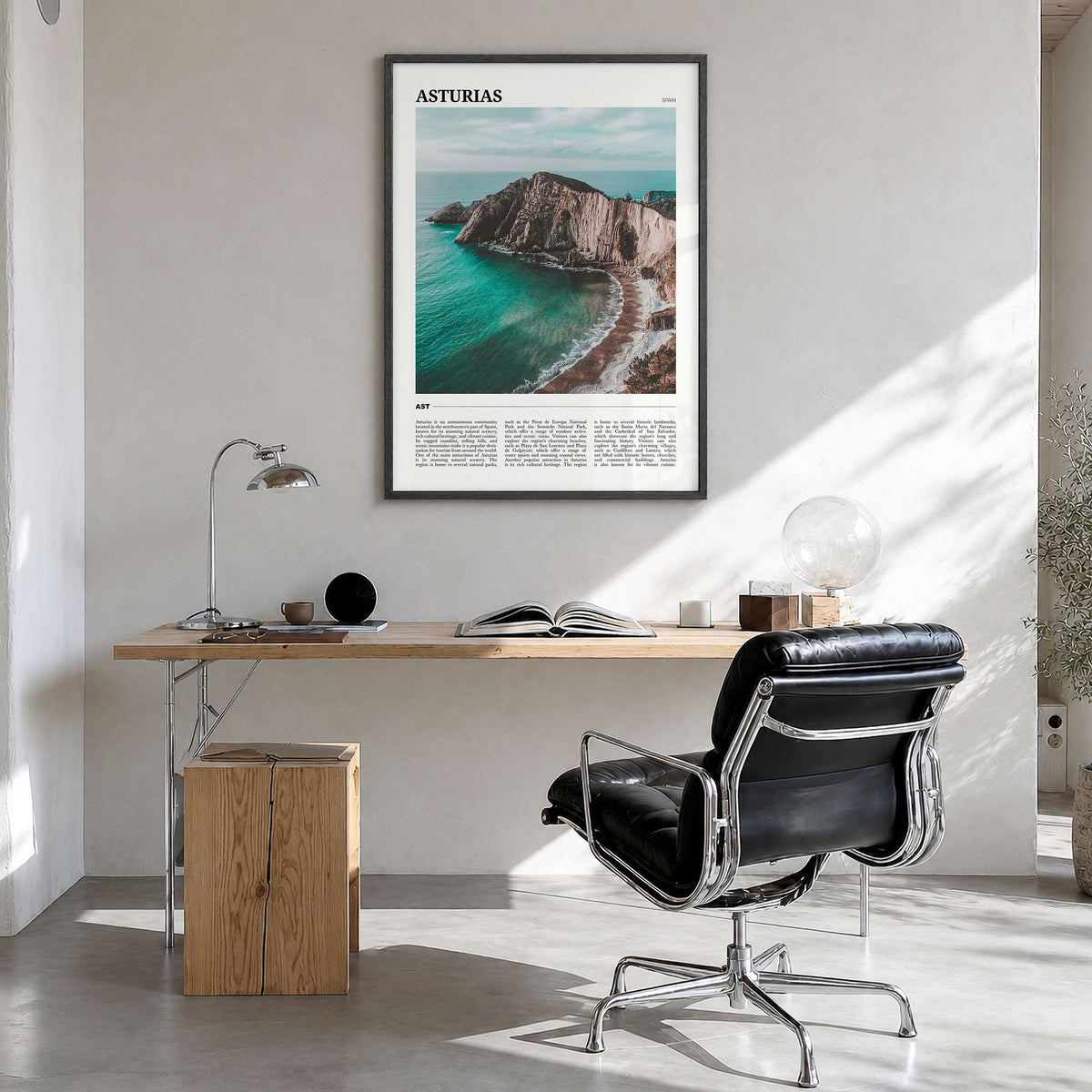 Asturias Travel Poster in a black wood frame, hanging in a bright home office