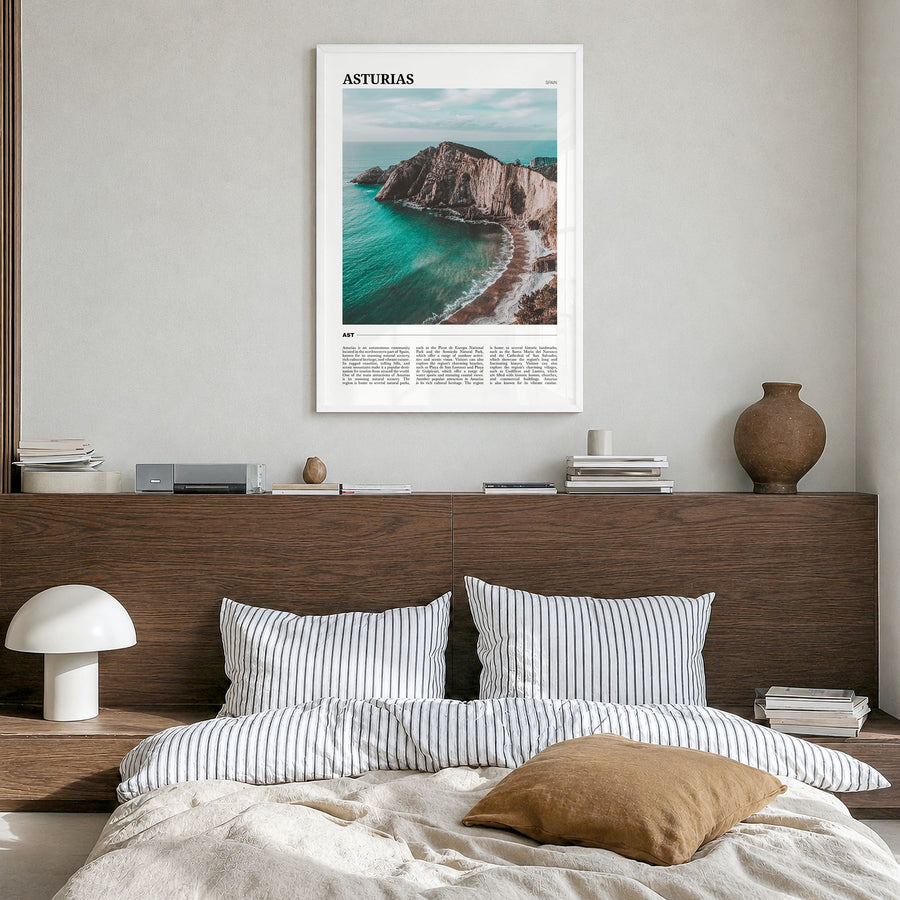 Asturias Travel Poster in a white wood frame, hanging in a bedroom