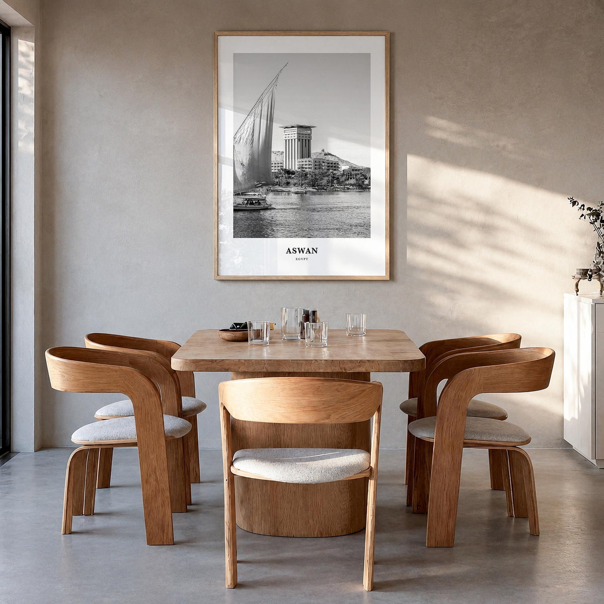 Aswan black & white classic poster of Egypt – vertical wall art in natural wood frame, hanging on wall