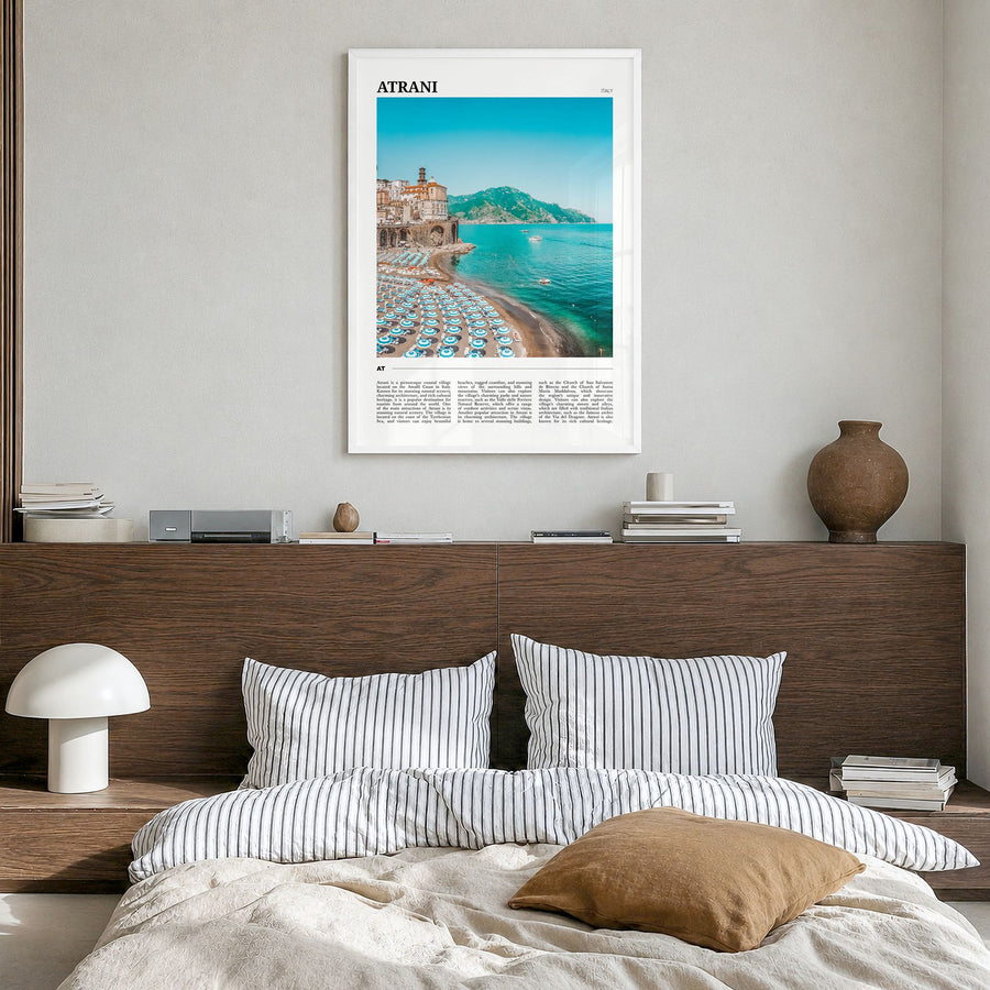 Atrani Travel Poster in a white wood frame, hanging in a bedroom