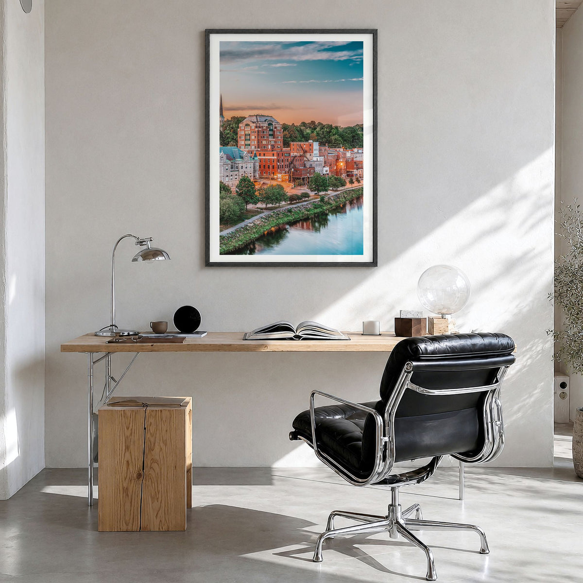 Augusta Photo Poster in a black wood frame, hanging in a bright home office, white border