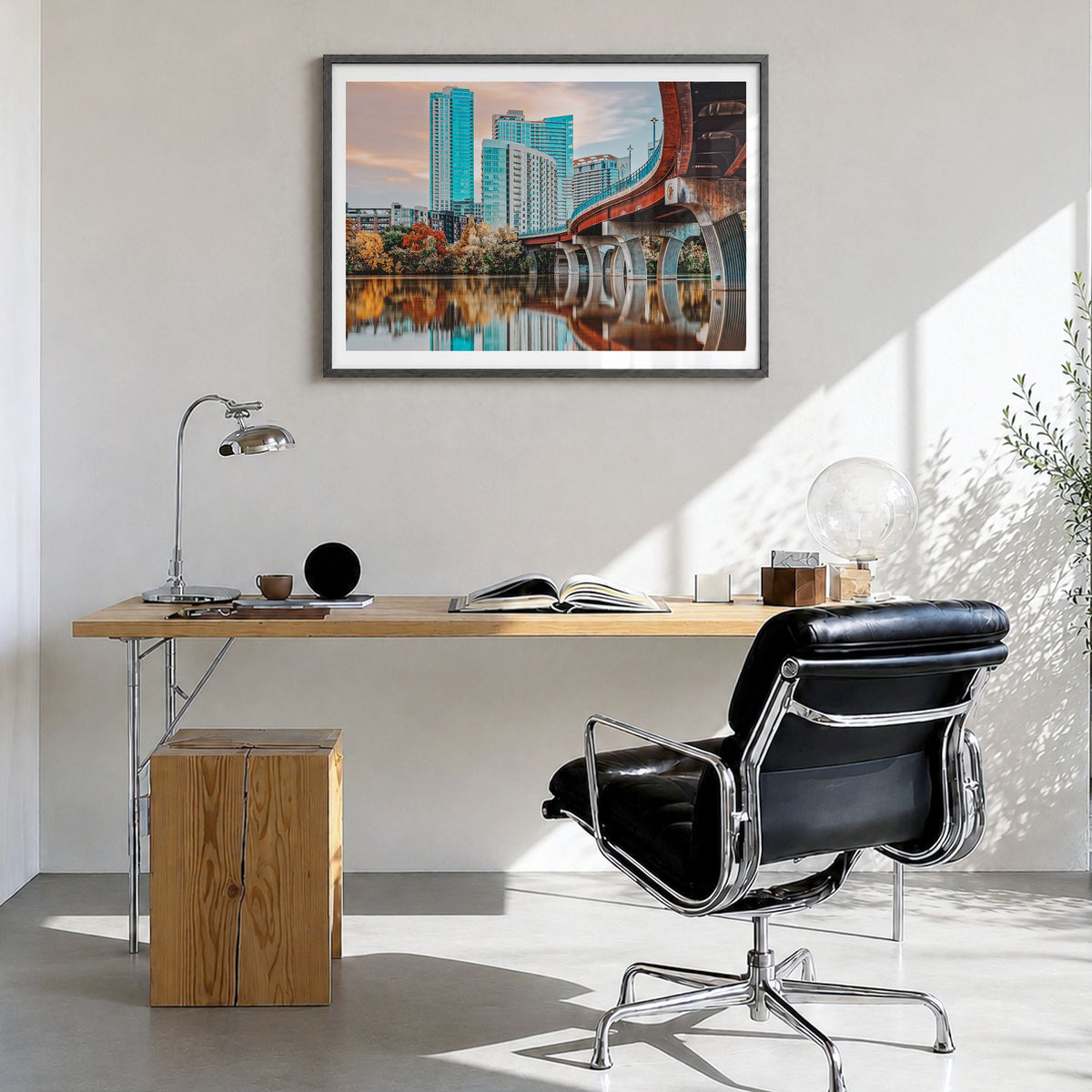 Austin Photo Poster in a black wood frame, hanging in a bright home office, white border