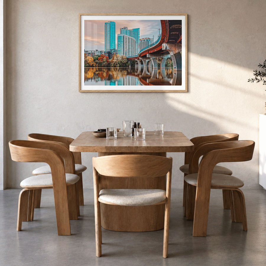 Austin Photo Poster in a natural wood frame, hanging in a dining room, white border