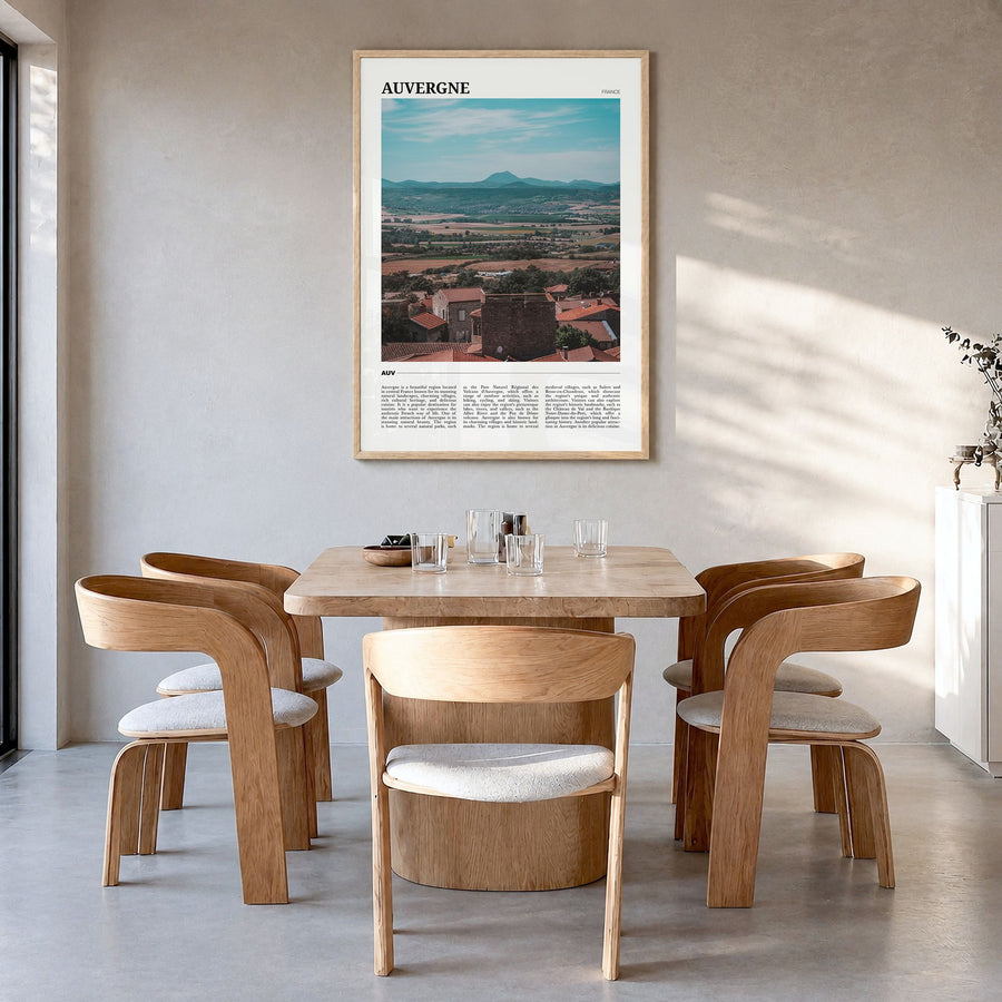 Auvergne Travel Poster in a natural wood frame, hanging in a dining room