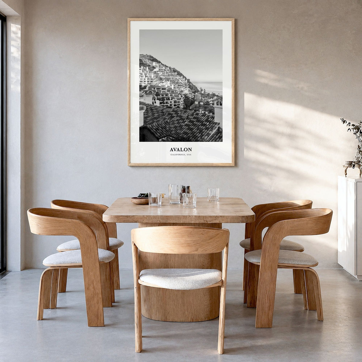 Avalon, California Classic Poster in a natural wood frame, hanging in a dining room
