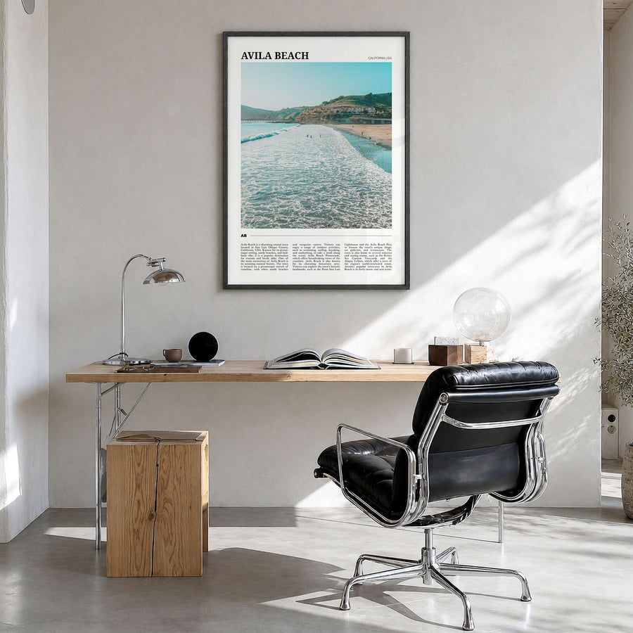Avila Beach Travel Poster in a black wood frame, hanging in a bright home office