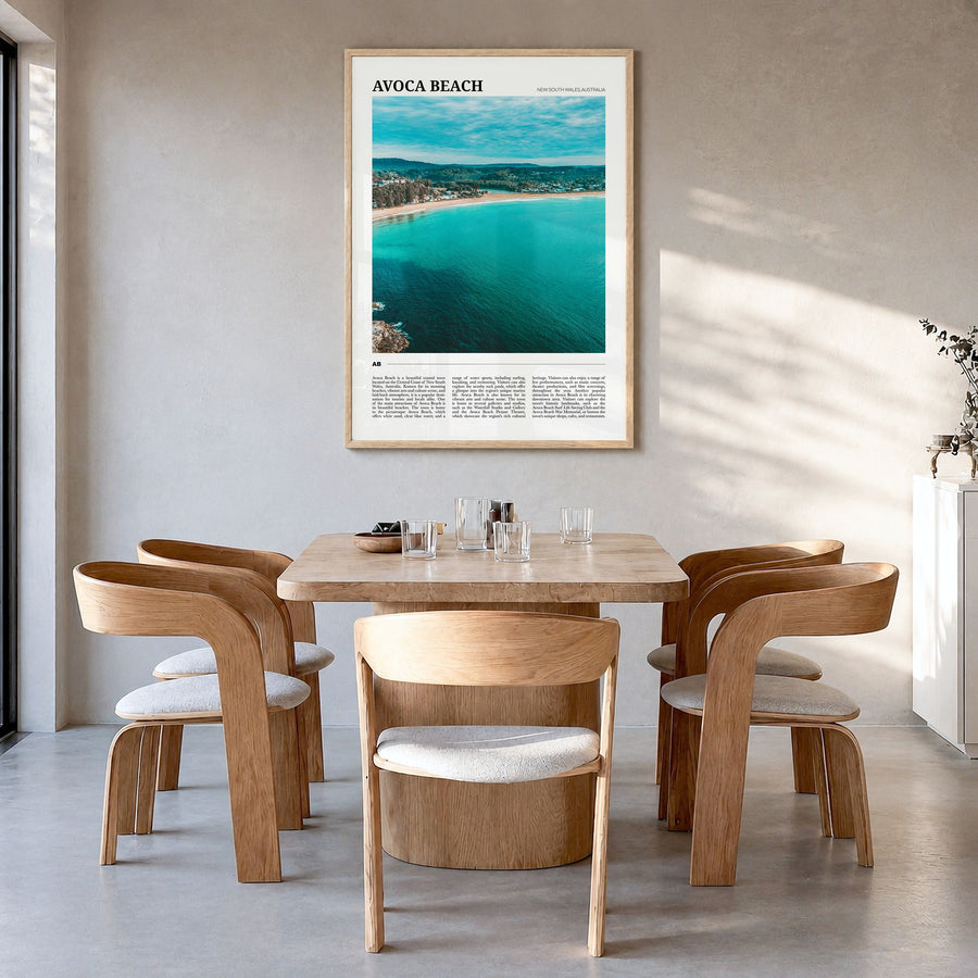 Avoca Beach Travel Poster in a natural wood frame, hanging in a dining room