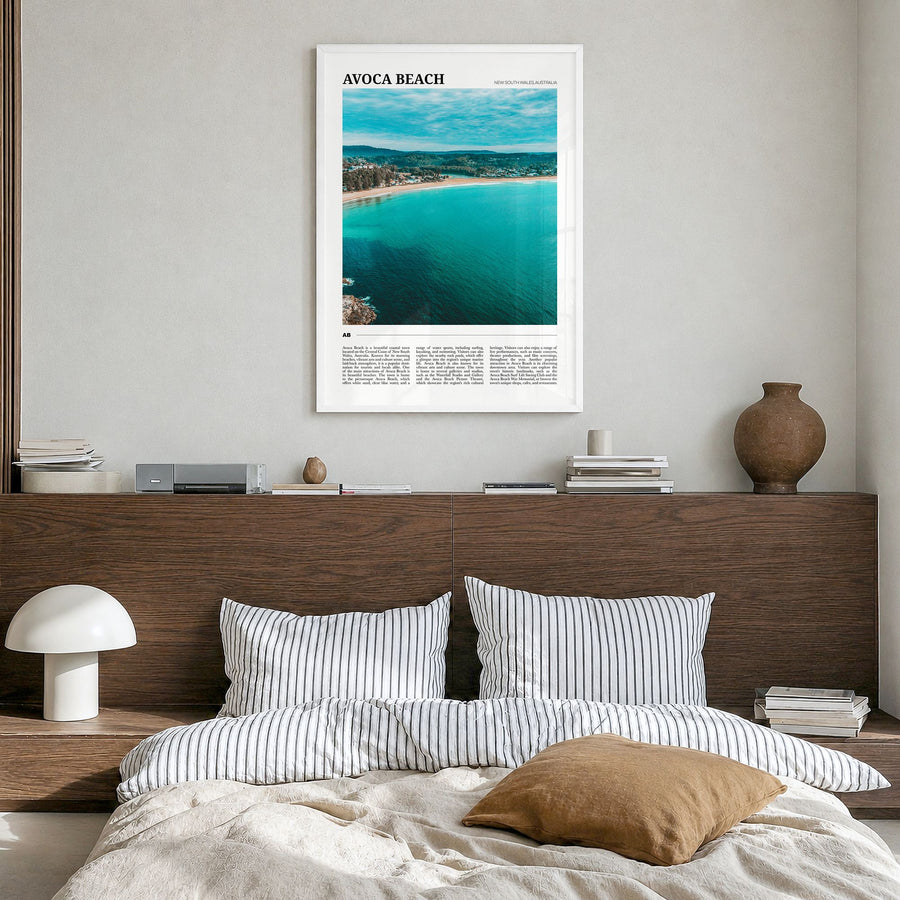 Avoca Beach Travel Poster in a white wood frame, hanging in a bedroom