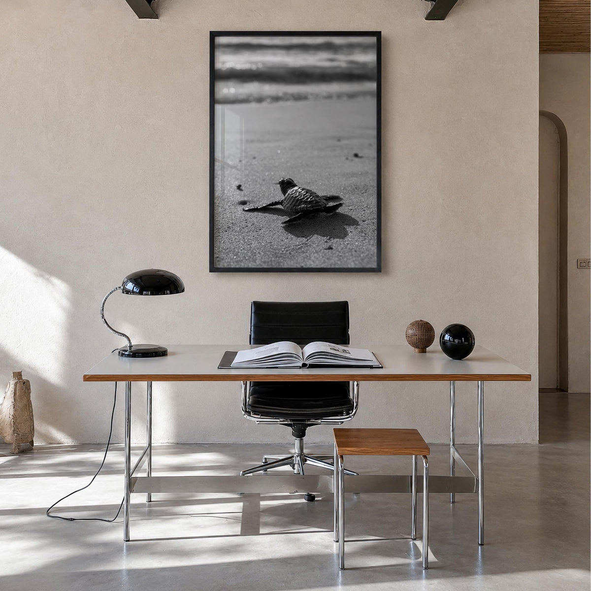 Baby Turtle black & white photo poster – vertical wall art in black wood frame, hanging on wall