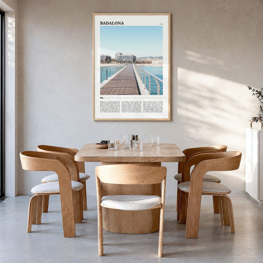 Badalona Travel Poster in a natural wood frame, hanging in a dining room