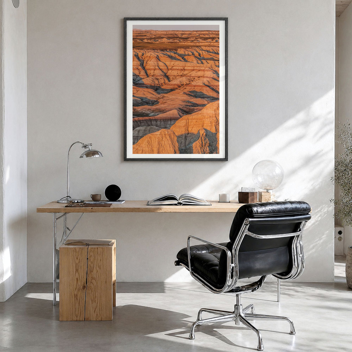 Badlands National Park Photo Poster in a black wood frame, hanging in a bright home office, white border