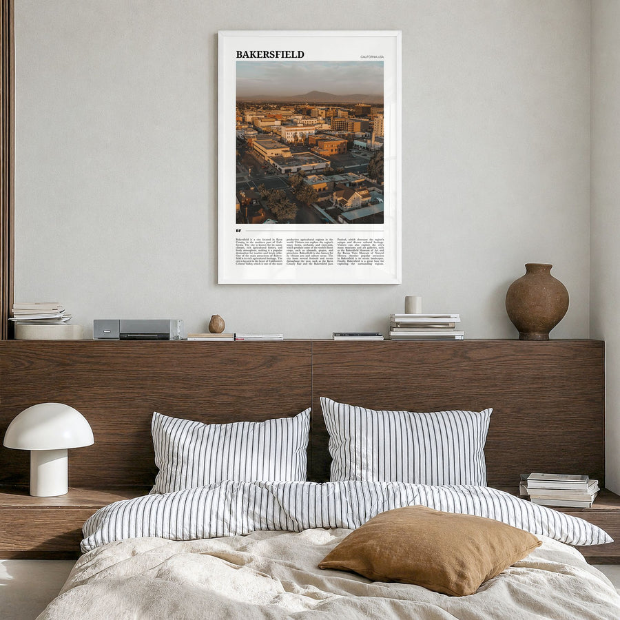 Bakersfield Travel Poster in a white wood frame, hanging in a bedroom