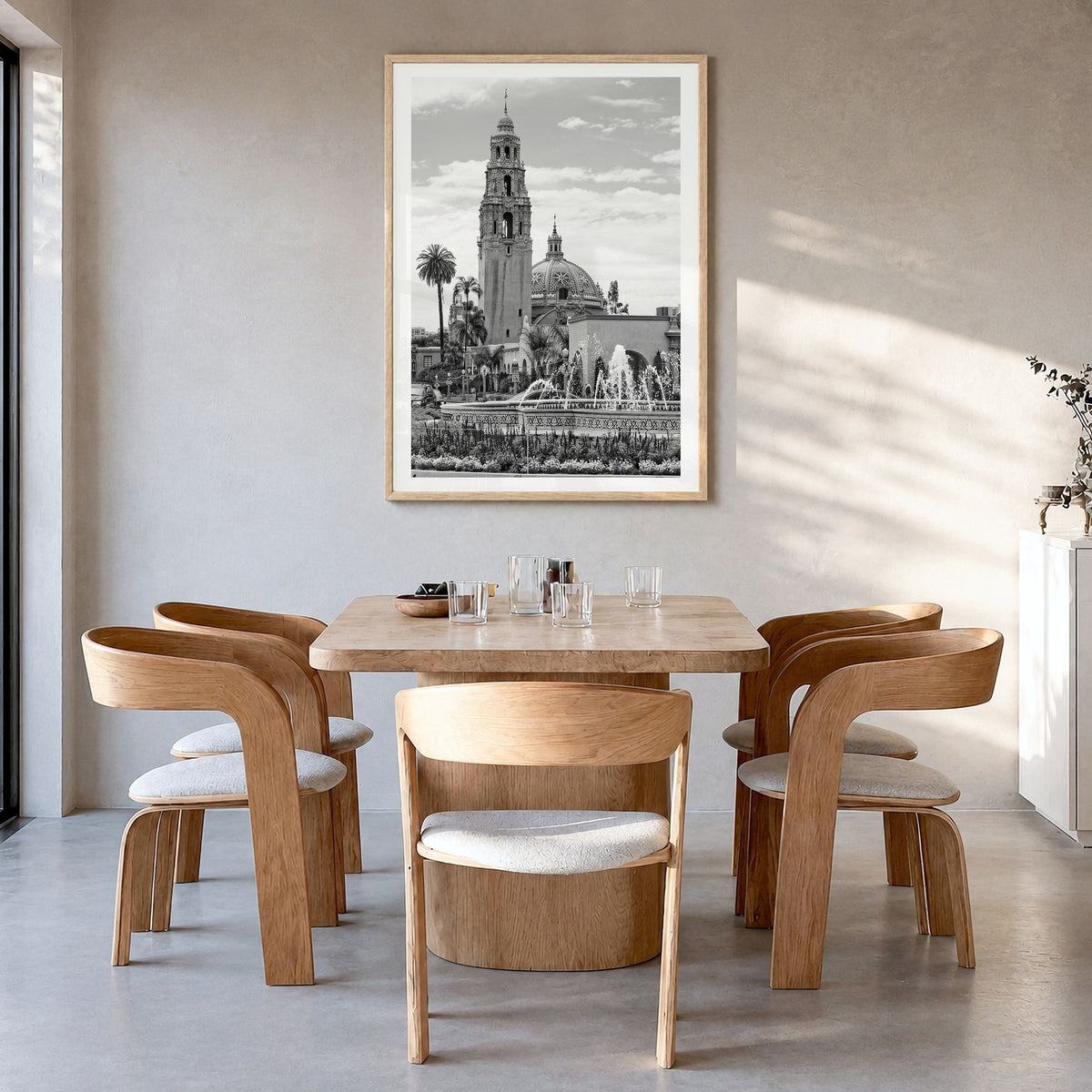 Balboa Park Photo Poster in a natural wood frame, hanging in a dining room, white border