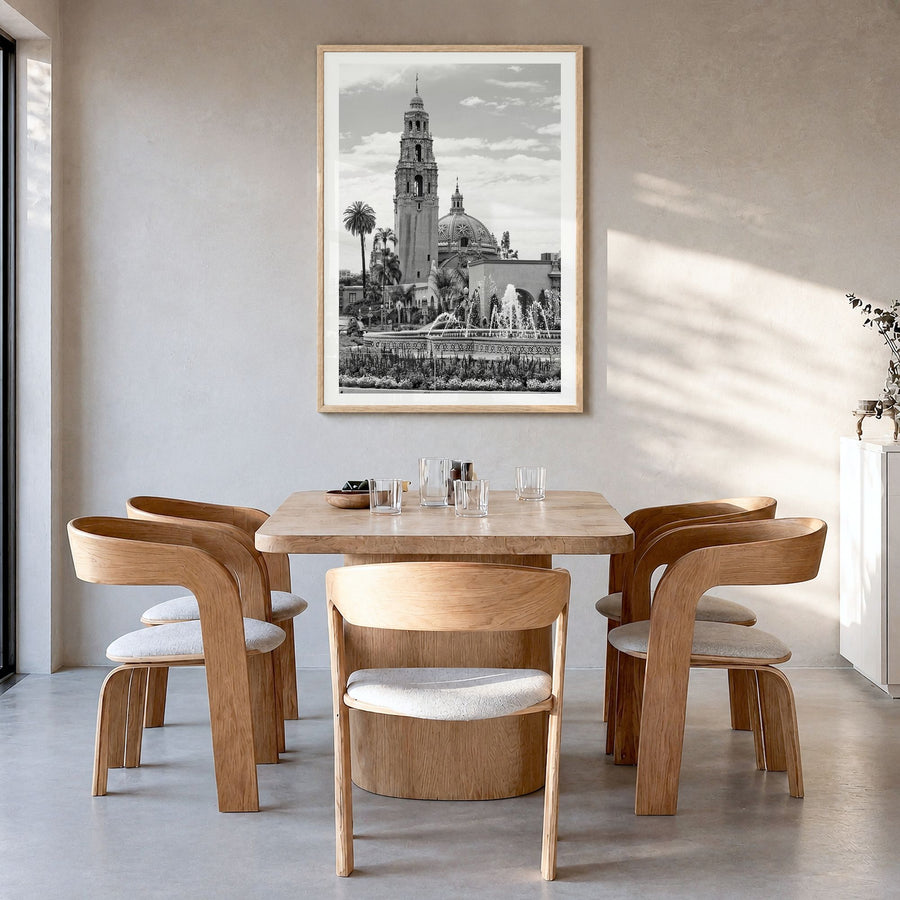 Balboa Park Photo Poster in a natural wood frame, hanging in a dining room, white border