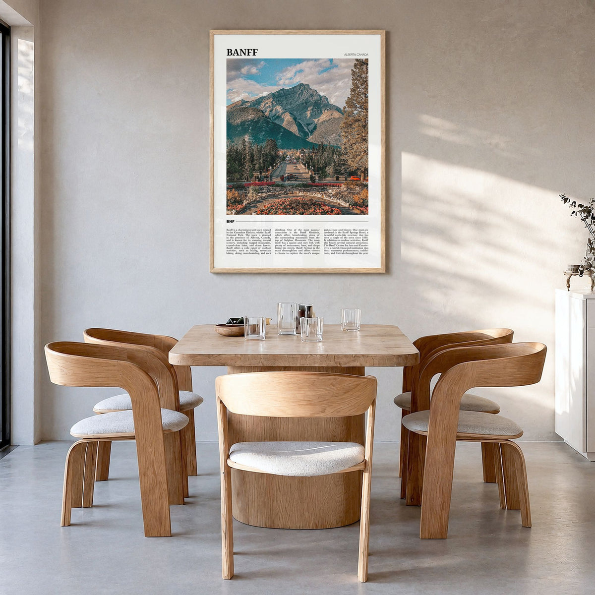 Banff Travel Poster in a natural wood frame, hanging in a dining room
