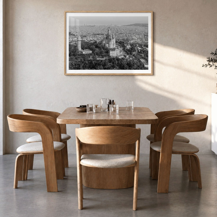 Barcelona Photo Poster in a natural wood frame, hanging in a dining room, white border