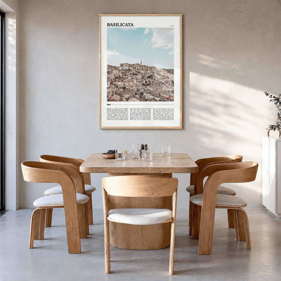 Basilicata Travel Poster in a natural wood frame, hanging in a dining room