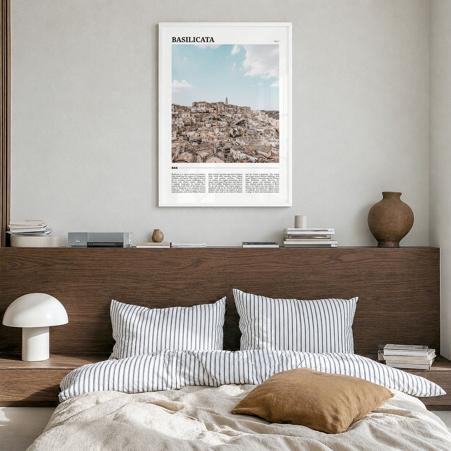 Basilicata Travel Poster in a white wood frame, hanging in a bedroom