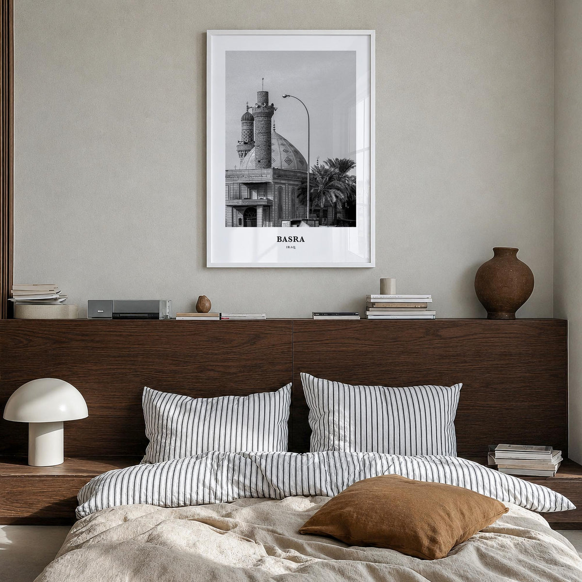 Basra black & white classic poster of Iraq – vertical wall art in white wood frame, hanging on wall