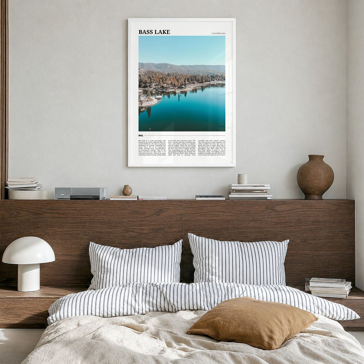 Bass Lake Travel Poster in a white wood frame, hanging in a bedroom