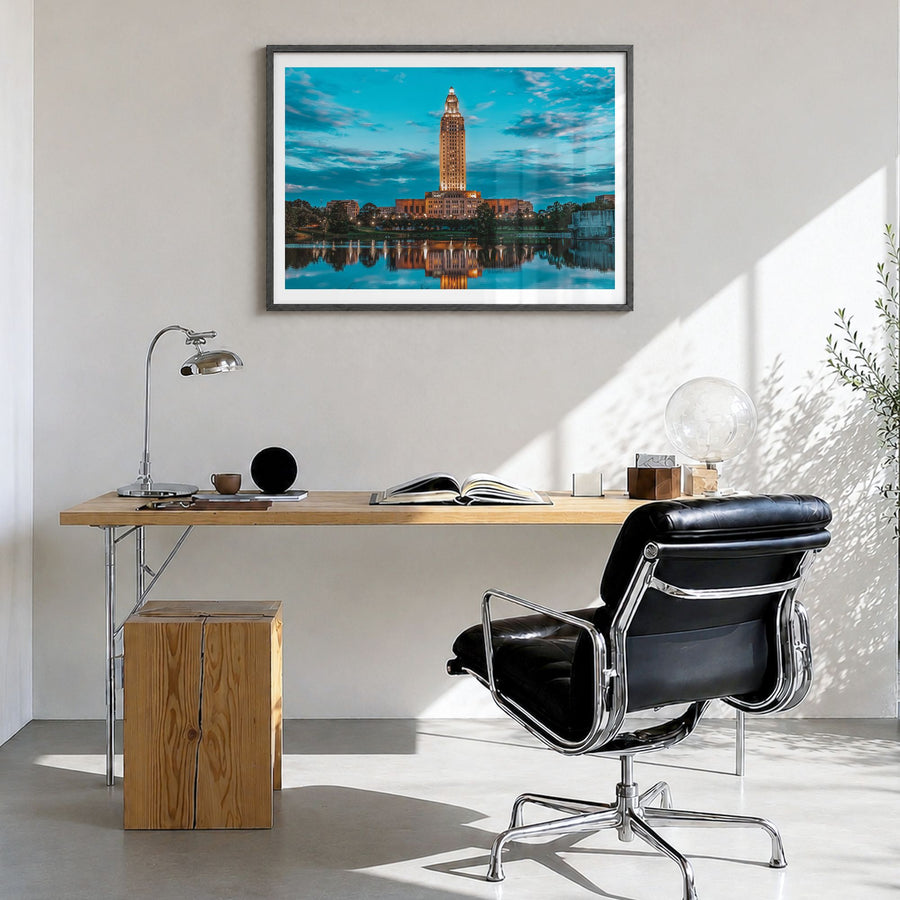 Baton Rouge Photo Poster in a black wood frame, hanging in a bright home office, white border