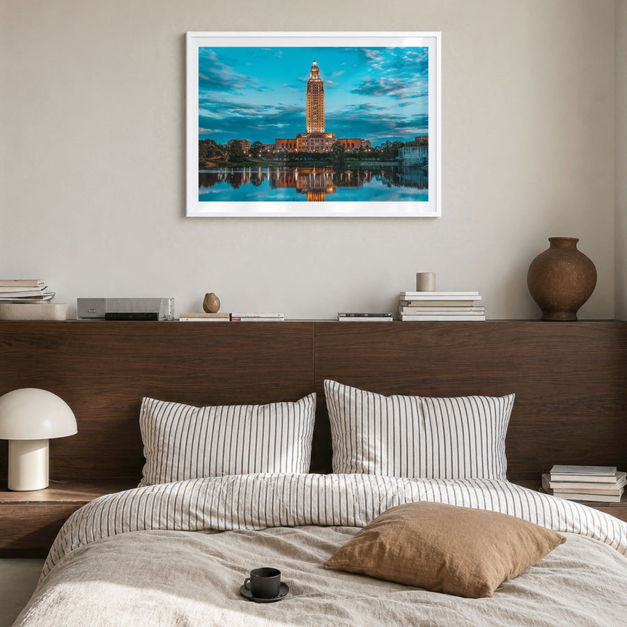 Baton Rouge Photo Poster in a white wood frame, hanging in a bedroom, white border