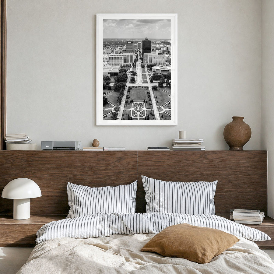Baton Rouge Photo Poster in a white wood frame, hanging in a bedroom, white border