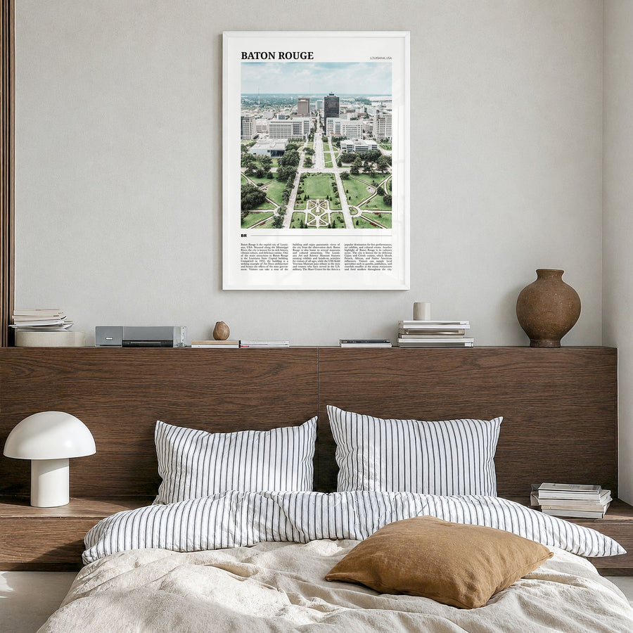 Baton Rouge Travel Poster in a white wood frame, hanging in a bedroom