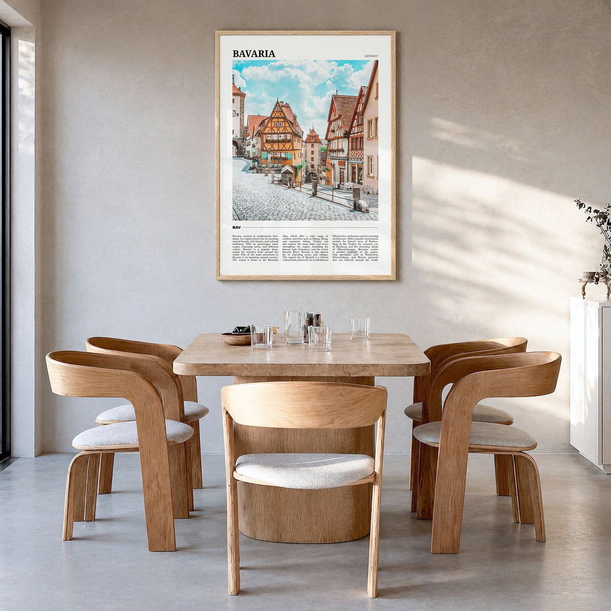 Bavaria Travel Poster in a natural wood frame, hanging in a dining room