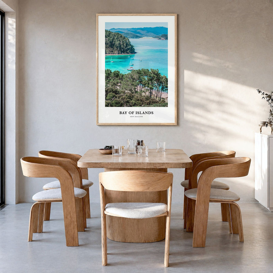 Bay of Islands Classic Poster in a natural wood frame, hanging in a dining room