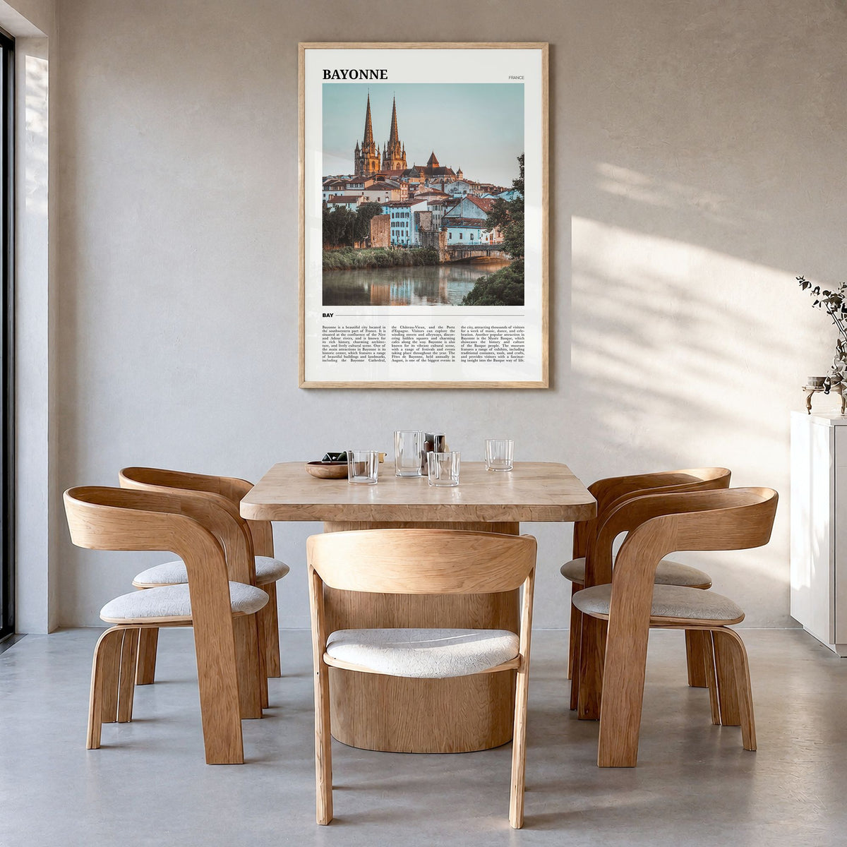 Bayonne, France Travel Poster in a natural wood frame, hanging in a dining room