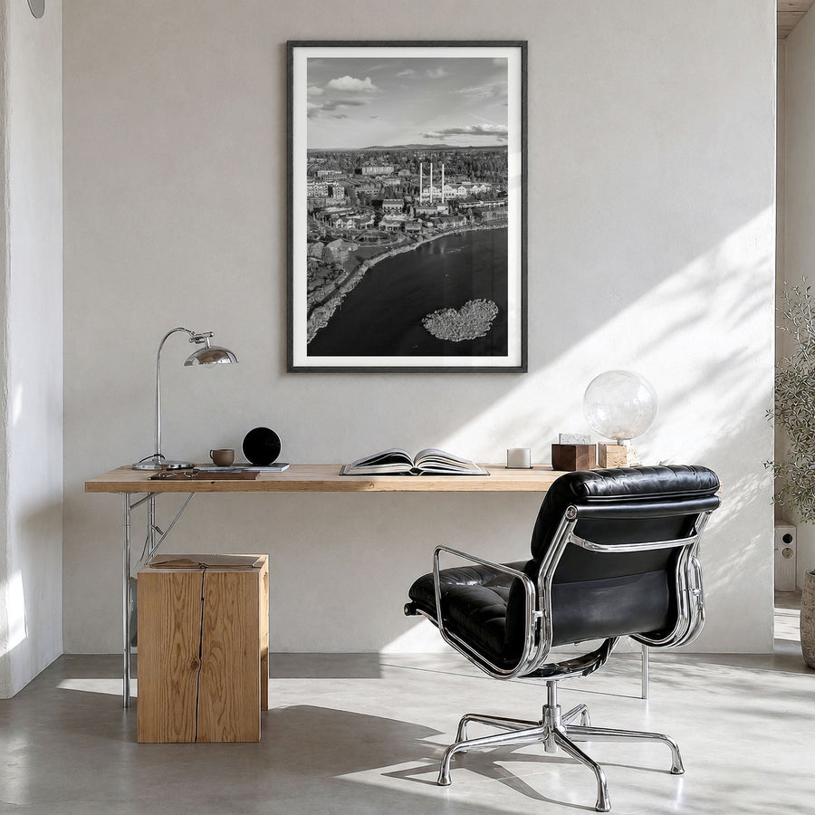 Bend Photo Poster in a black wood frame, hanging in a bright home office, white border
