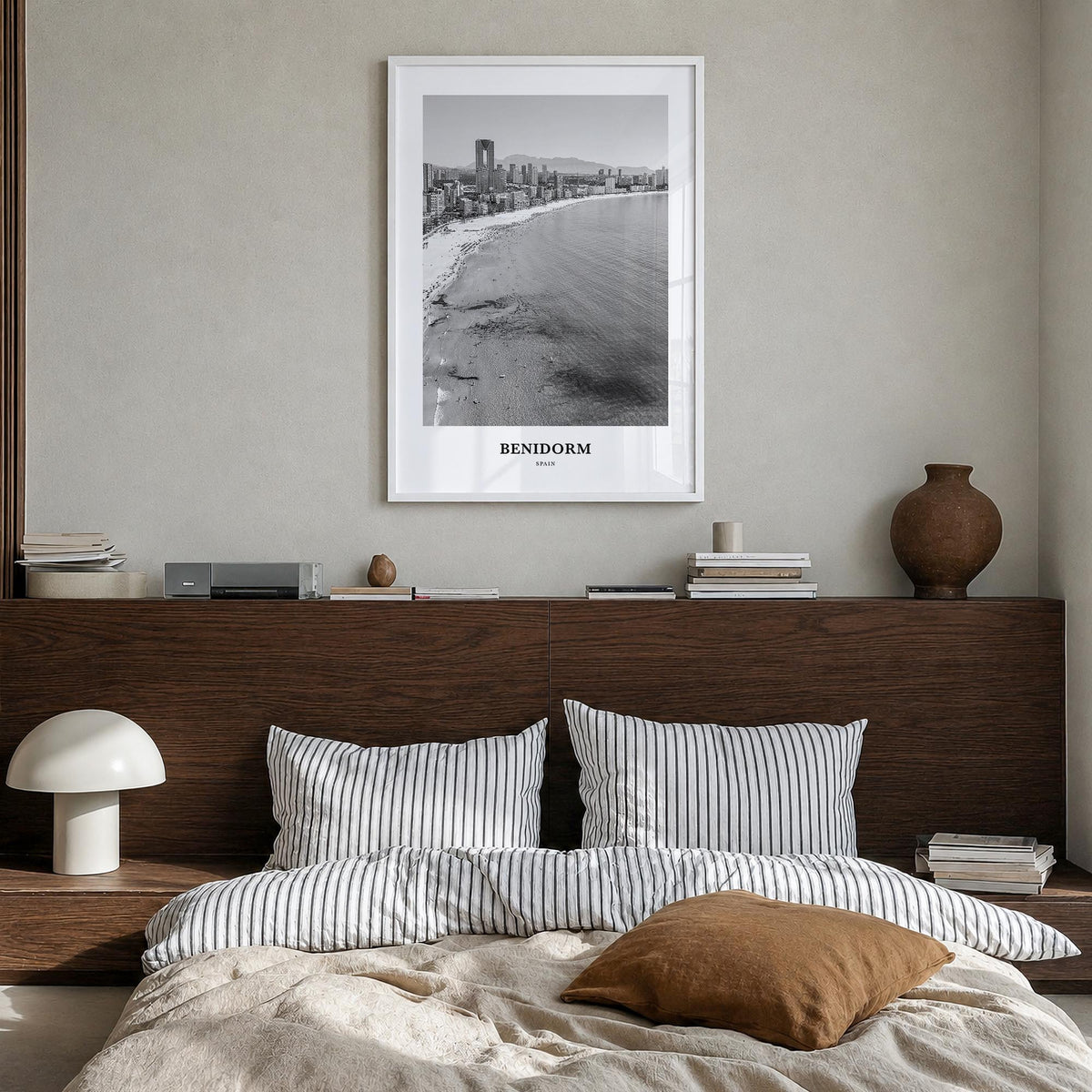 Benidorm black & white classic poster of Spain – vertical wall art in white wood frame, hanging on wall