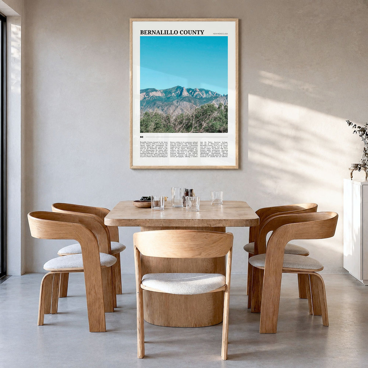 Bernalillo County Travel Poster in a natural wood frame, hanging in a dining room