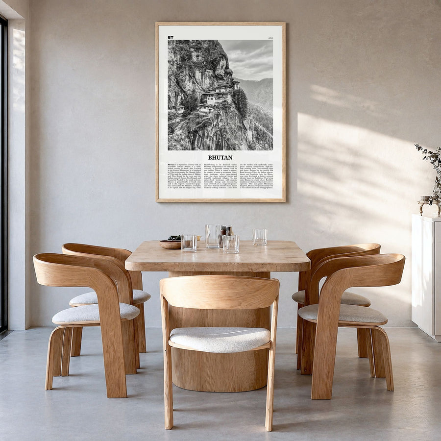 Bhutan Newspaper Poster in a natural wood frame, hanging in a dining room